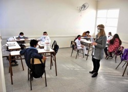 Maestra y alumnos con distancia social